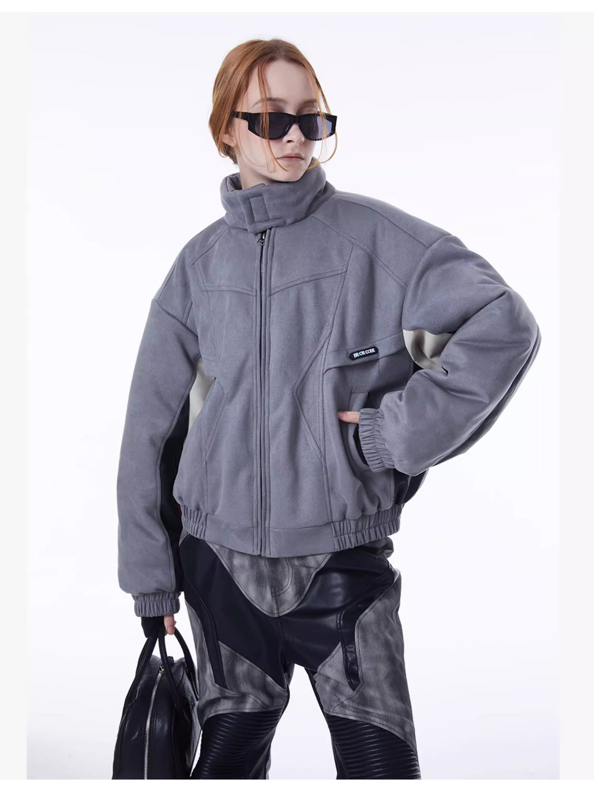 ERRORCODE ROBOT haze-blue contrast-panel padded racing jacket, front modeled view with zipped collar and a hand in the pocket