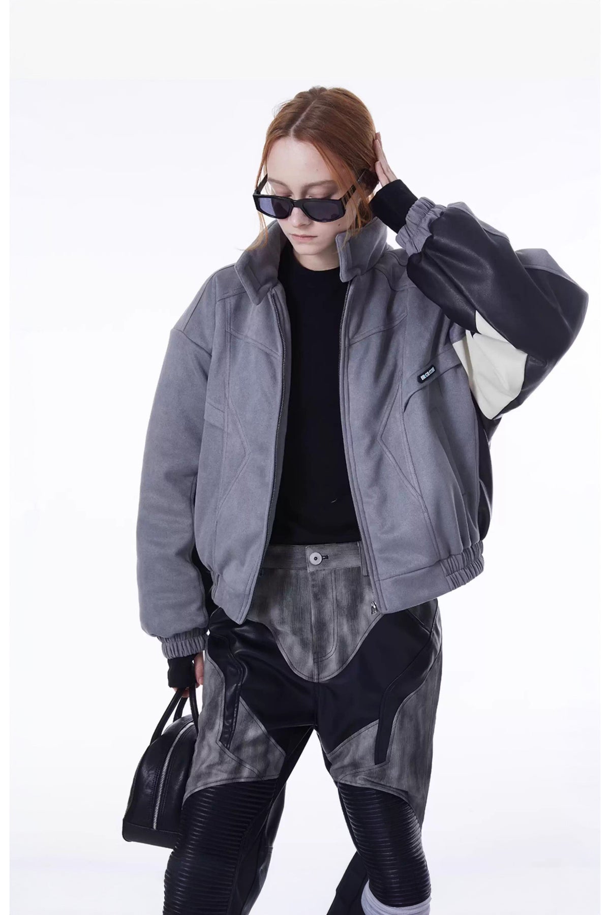 ERRORCODE ROBOT haze-blue contrast-panel padded racing jacket, open-front modeled view with one hand raised