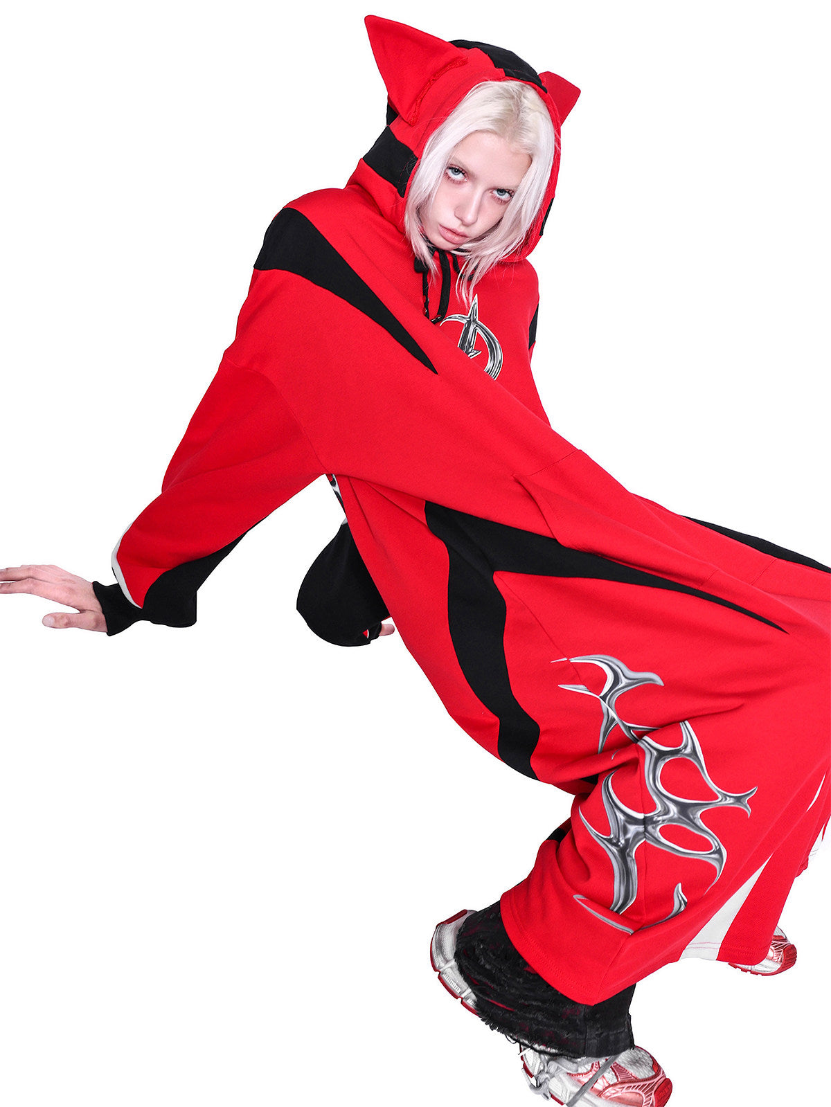 PINKSPINK CAT RACER longline hoodie in red black — crouching front modeled view with the cat-ear hood raised