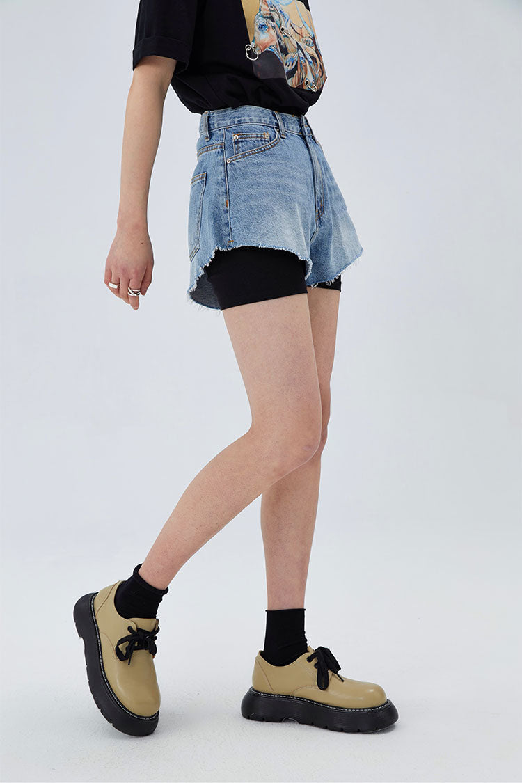 CLICK CHIC HACKWRENCH layered denim shorts, side-front view over black biker shorts