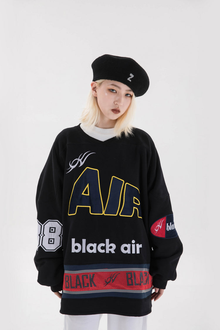 BLACKAIR varsity-letter sweatshirt, black, close front pose with head tilted