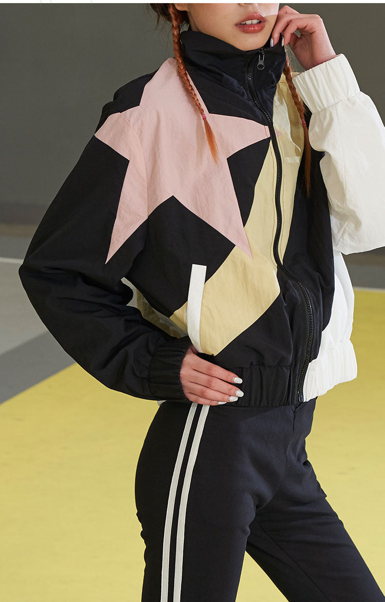 NEXT PASSPORT STAR COLOR BLOCK track jacket, waist-up styling with a hand at the collar