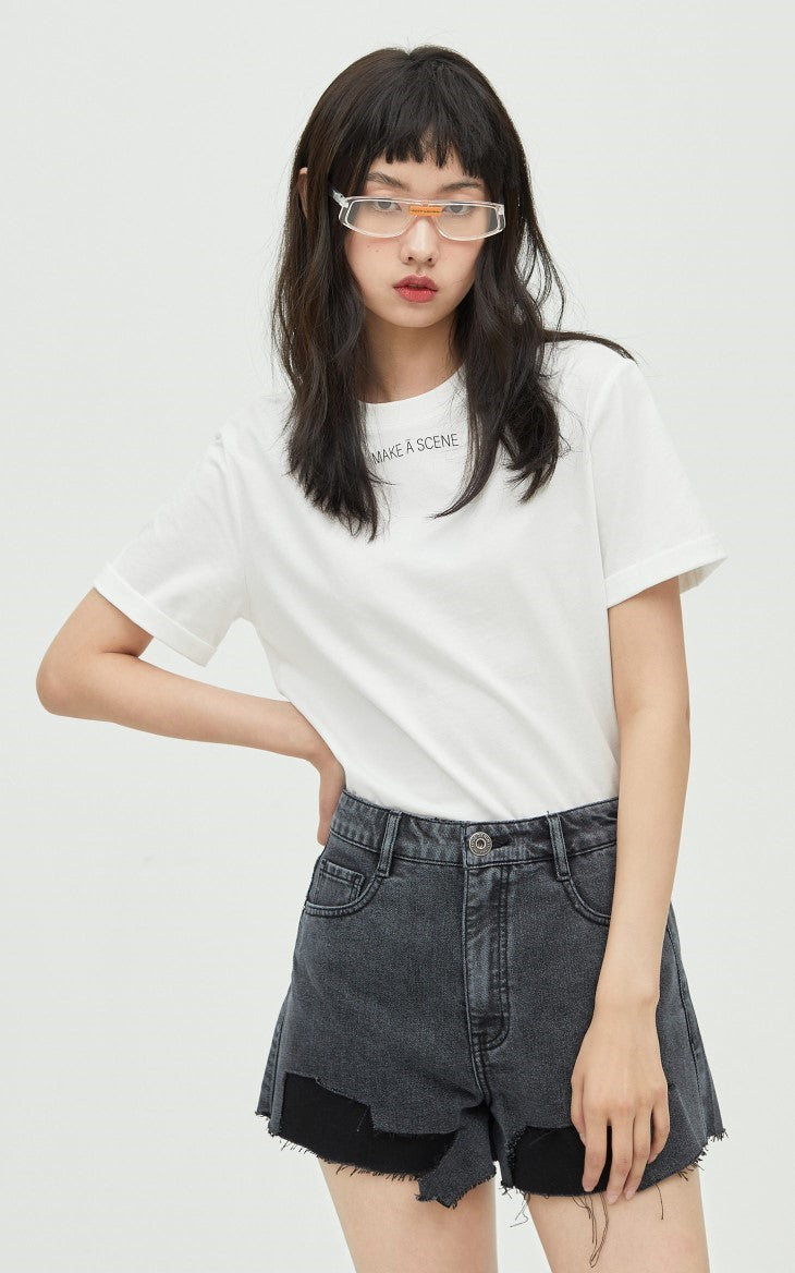 ONLY PAPER TEAR patchwork denim shorts, black, front pose with a white tee