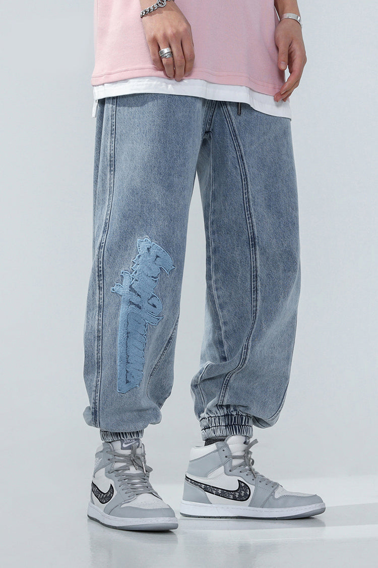 BJHG EMBROIDERED loose denim joggers, front on-body view of the rounded denim legs