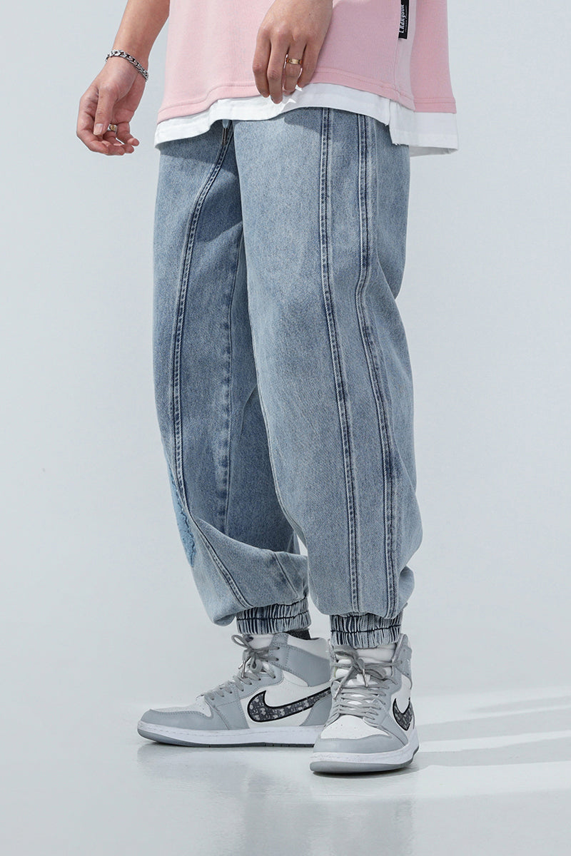 BJHG EMBROIDERED loose denim joggers, side-front styling showing the panel seams