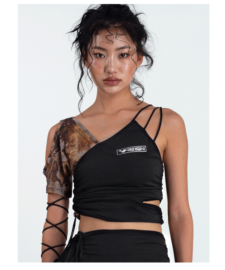 4RE1GN TIE-DYE SLEEVE asymmetric crop top, front waist-up view of the asymmetric straps