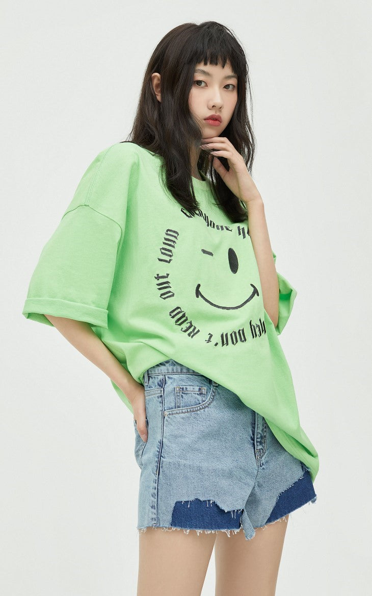 ONLY PAPER TEAR patchwork denim shorts, blue, front pose with a green tee