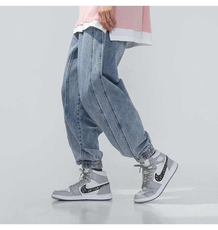 BJHG EMBROIDERED loose denim joggers, angled on-body view with one foot forward