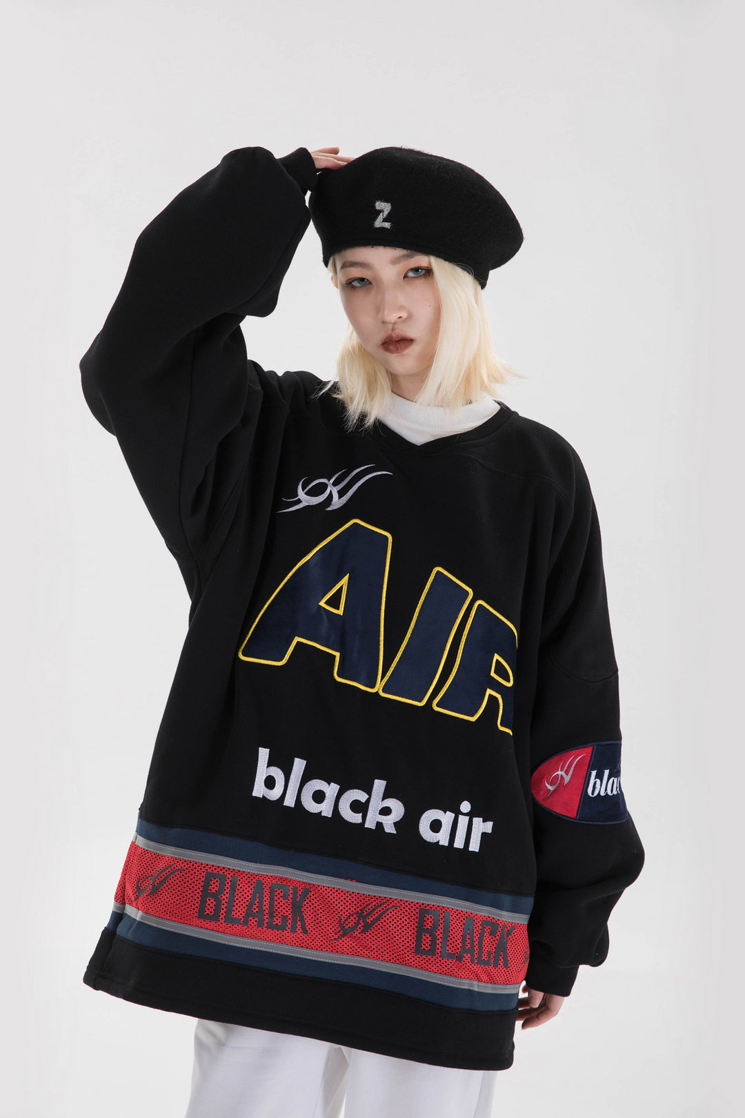 BLACKAIR varsity-letter sweatshirt, black, close pose touching beret