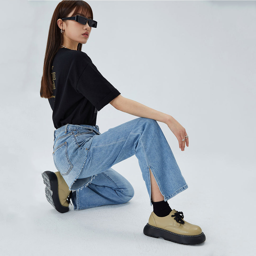 CLICK CHIC HACKWRENCH layered denim shorts, side seated pose over separate jeans