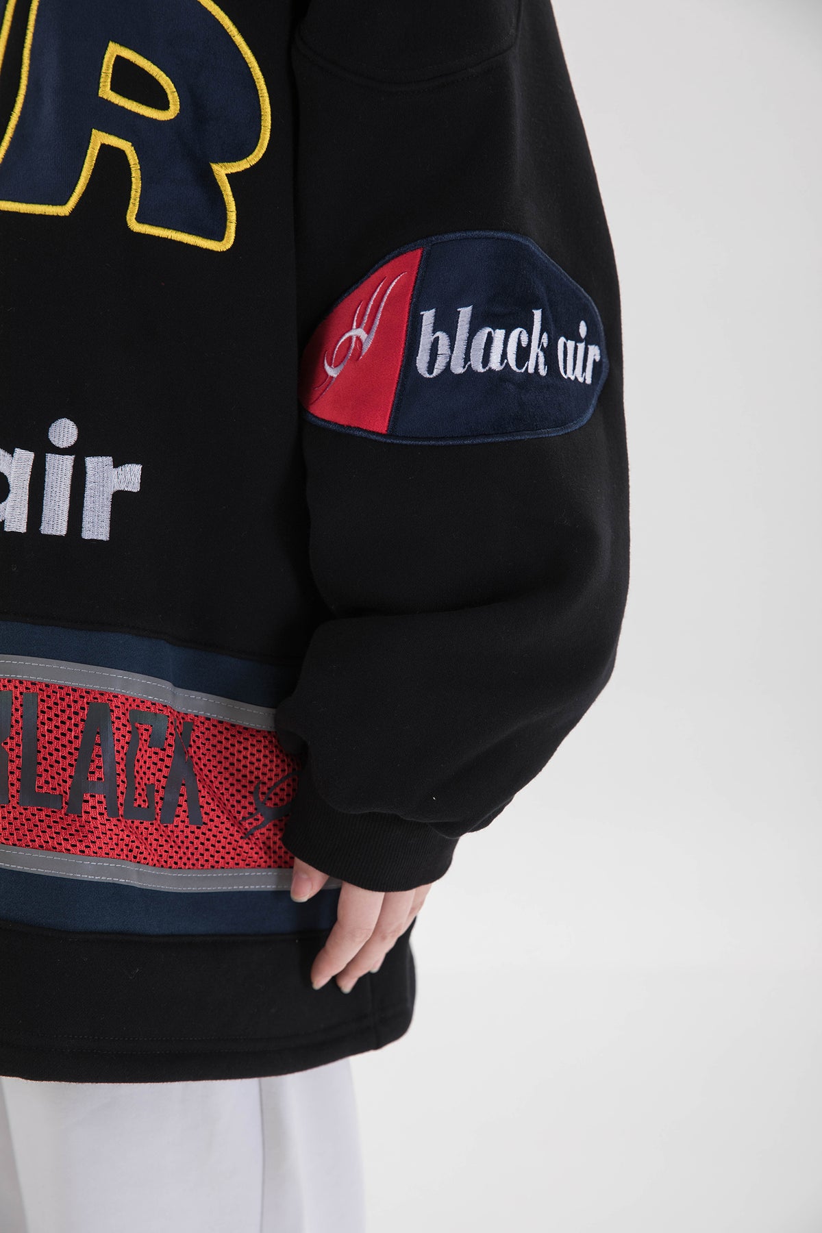 BLACKAIR varsity-letter sweatshirt, black, sleeve patch and red hem-band detail