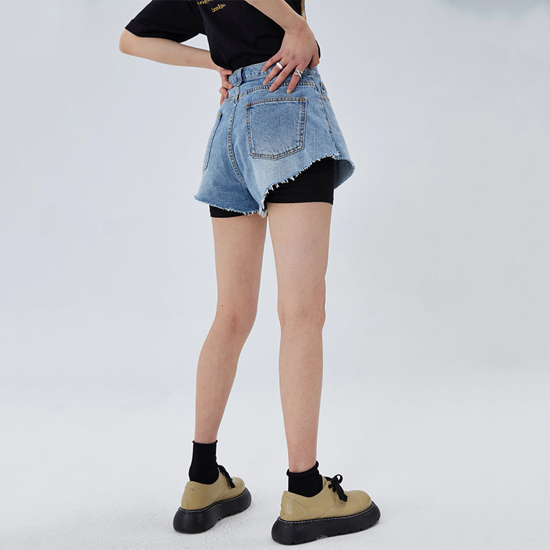 CLICK CHIC HACKWRENCH layered denim shorts, front pose with a hand at the waist over black biker shorts