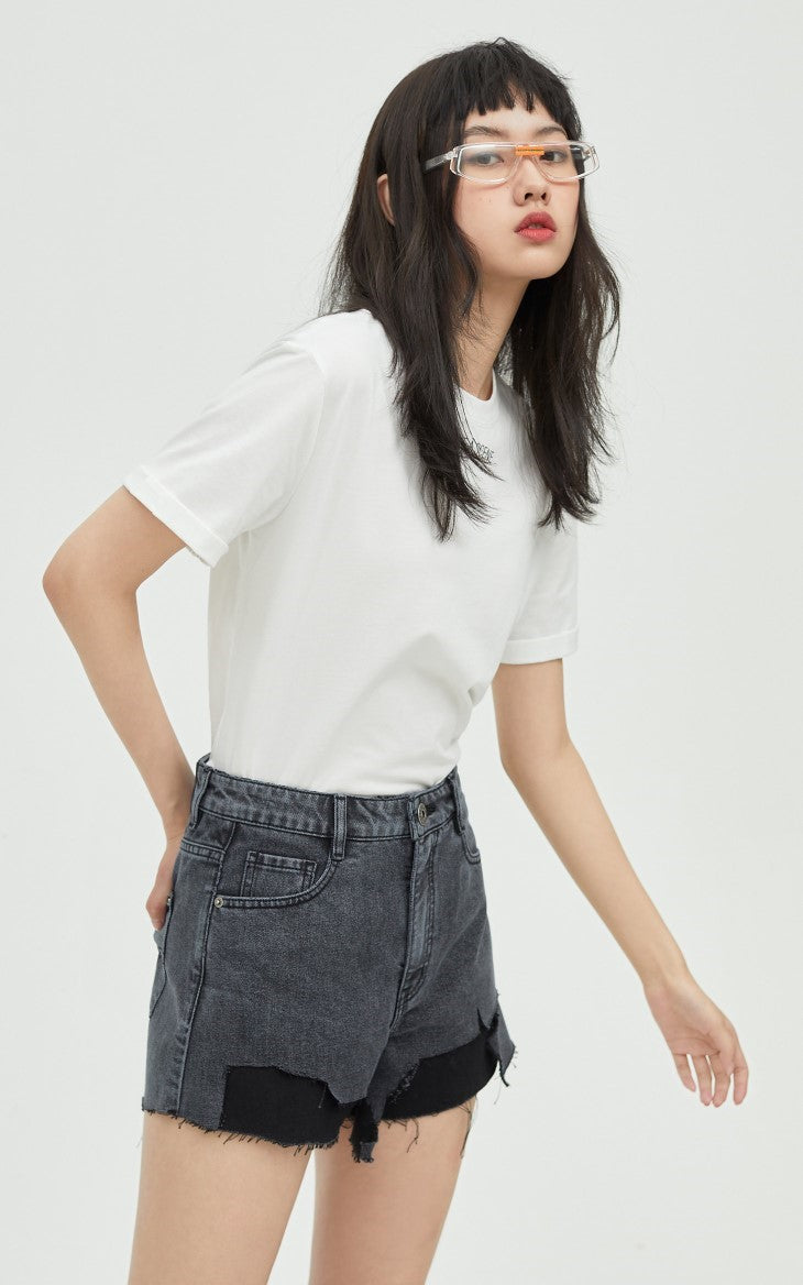 ONLY PAPER TEAR patchwork denim shorts, black, front pose leaning forward