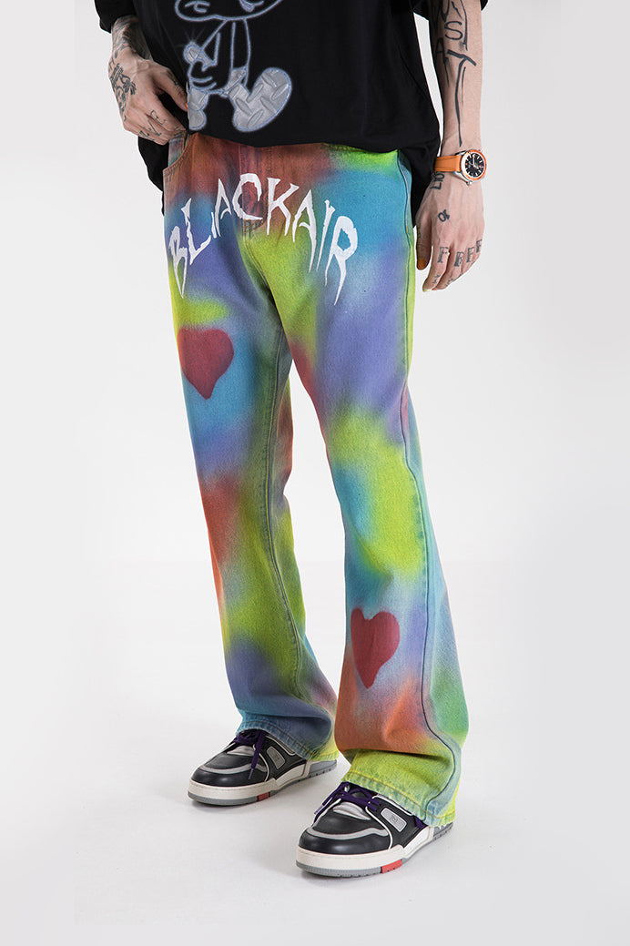 BLACKAIR INKJET LOVE GRAFFITI multicolor heart jeans, front styling with one hand near a pocket
