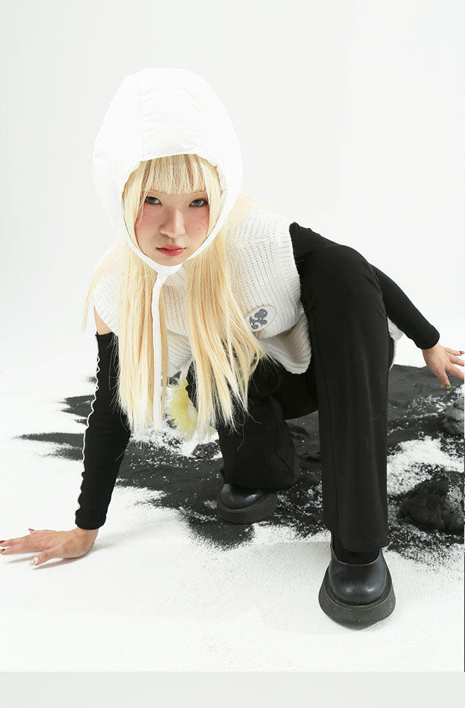 NEXT PASSPORT WHITE LAMB sleeveless turtleneck sweater, crouched styling with black pants
