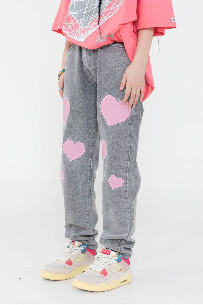 BLACKAIR BIG HEARTS pink-patch jeans, gray version, front pose with one leg turned
