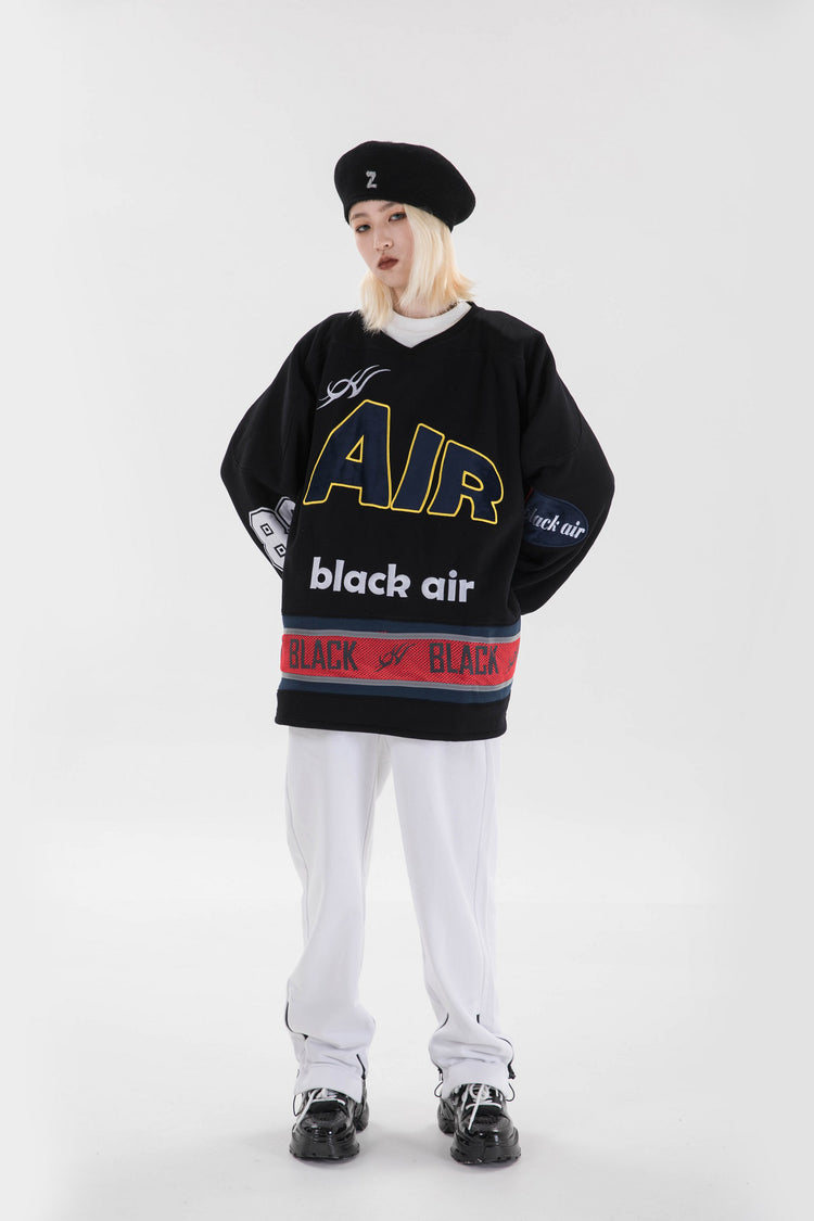 BLACKAIR varsity-letter sweatshirt, black, full hands-at-hips pose