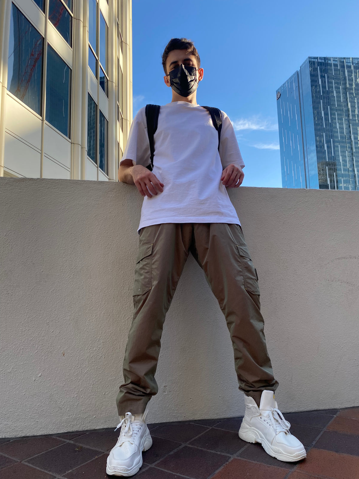 OFF-LABEL BASICS chunky high-top sneakers, white, full outdoor outfit against city skyline